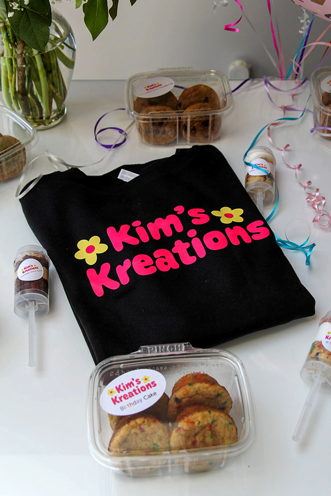 Kim's Kreations shirt surrounded by custom baked goods